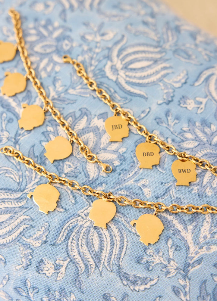 Gold child silhouette charm bracelet with initials